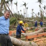 Mark Foster in Lumberyard showing devastation of palm trees.