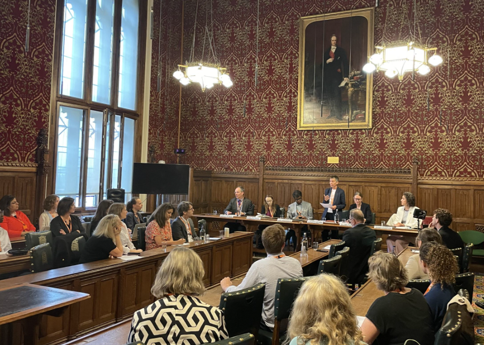 Commissioners and event attendees in a Parliamentary Committee room